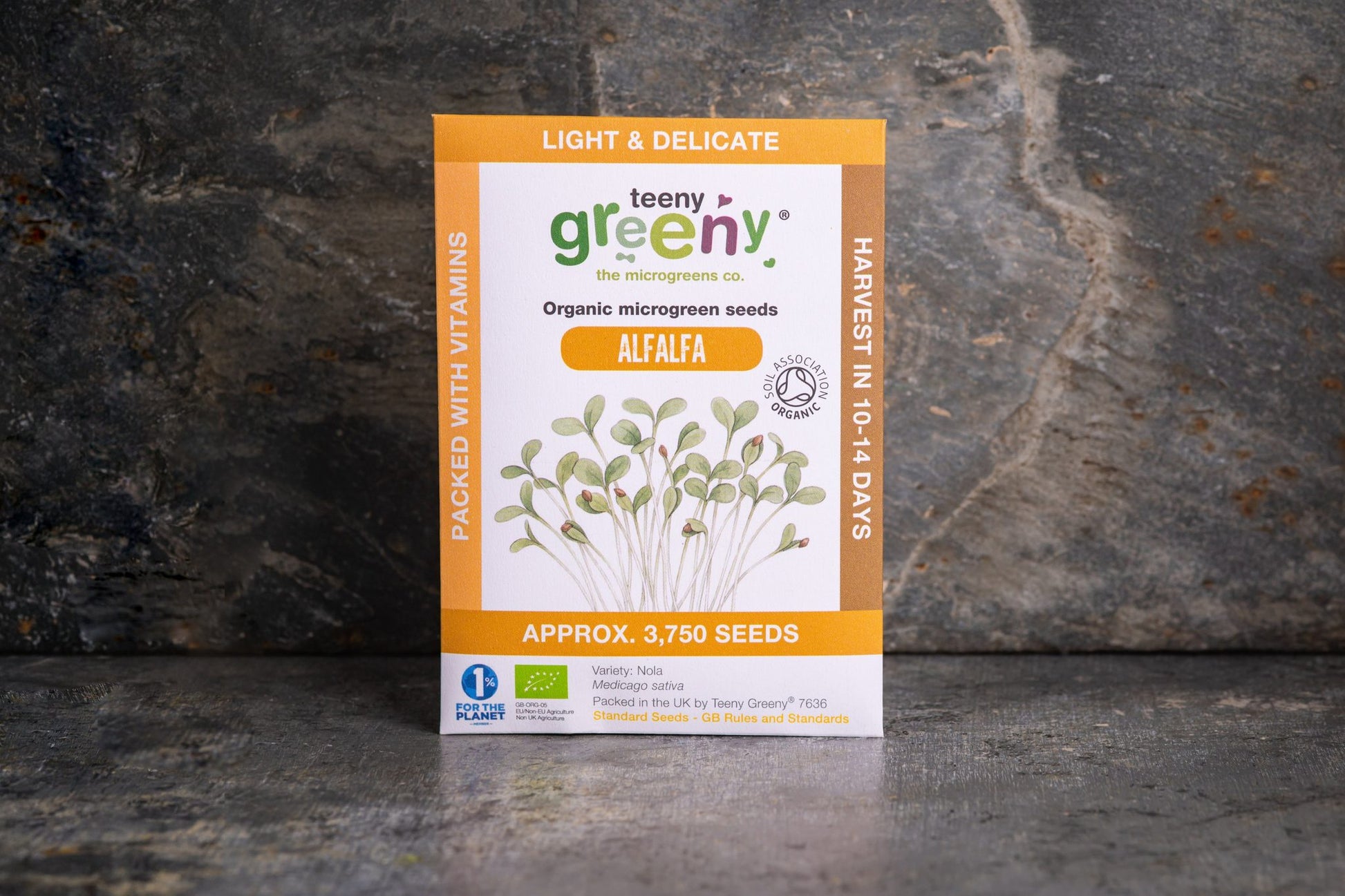 Teeny Greeny organic Alfalfa microgreen seed packet standing upright on dark slate background