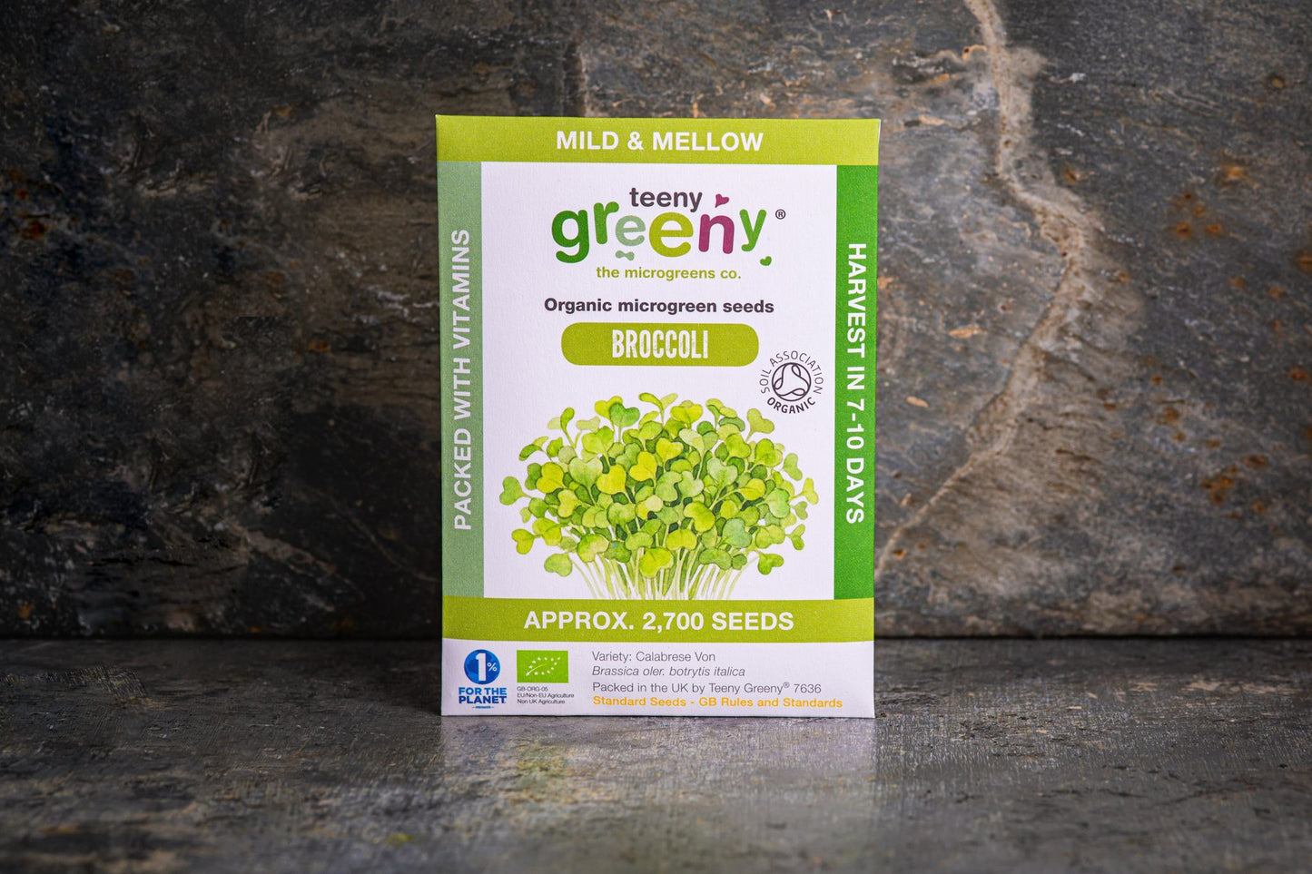 Teeny Greeny organic Broccoli microgreen seed packet standing upright on dark slate background