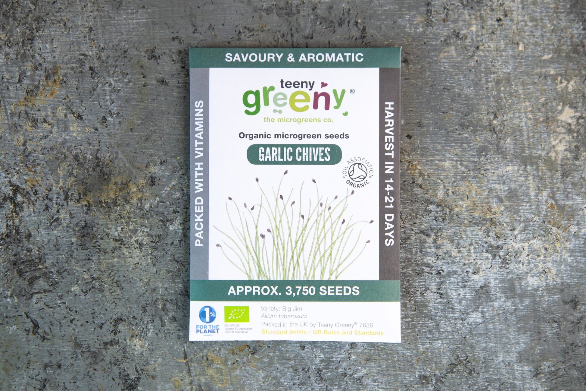Teeny Greeny garlic chive organic microgreen seed packet standing upright on slate background