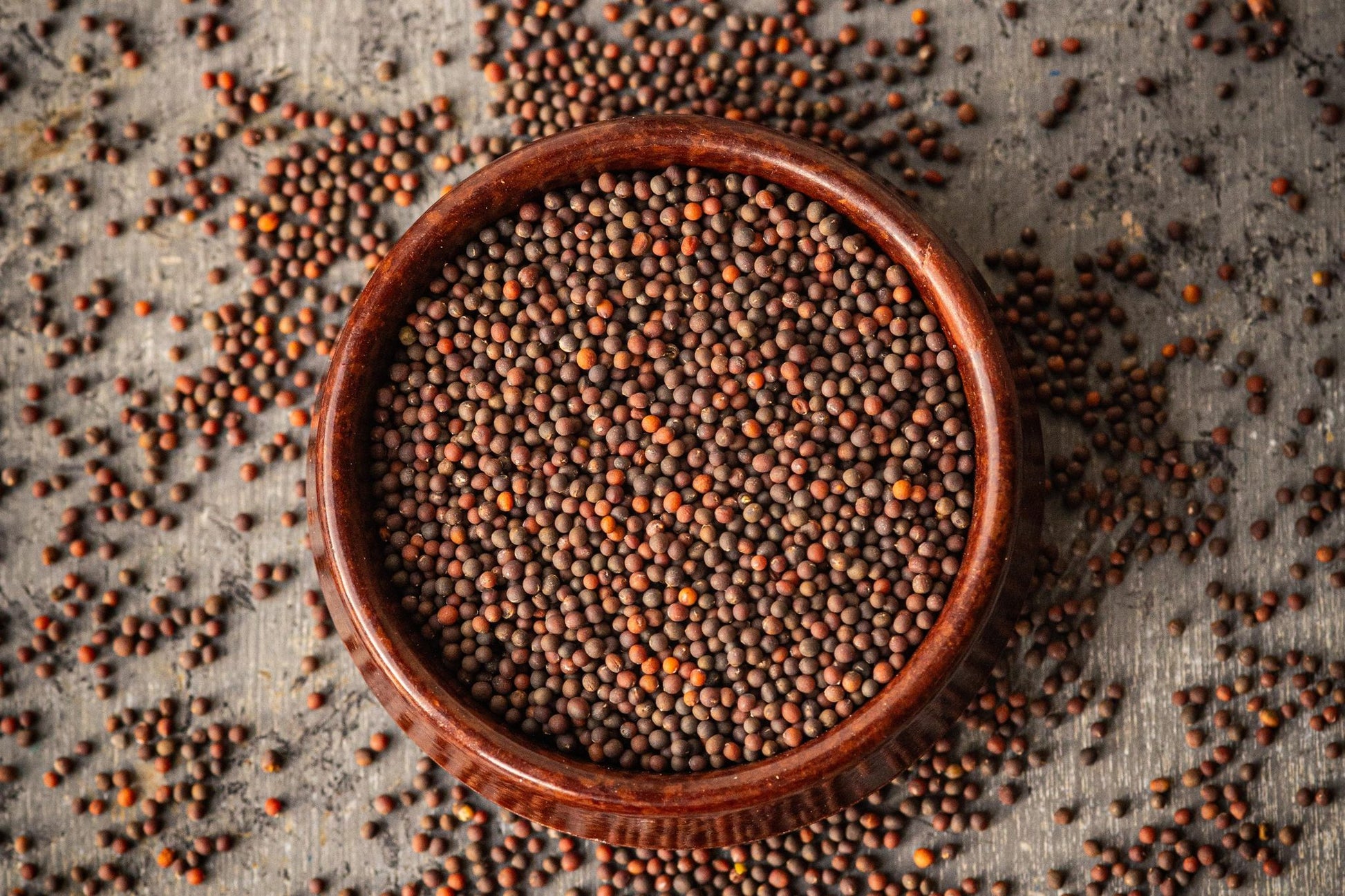 Teeny Greeny organic kale microgreen seeds close up in wooden bowl
