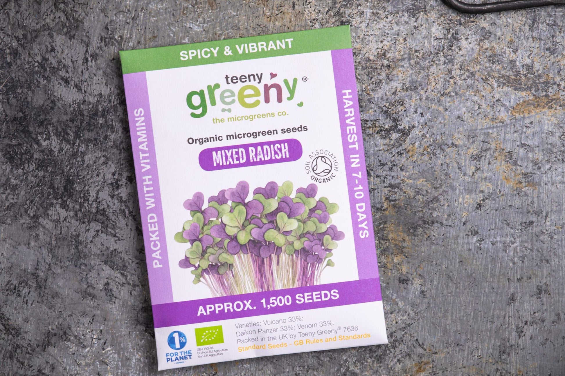 Teeny Greeny organic mixed radish microgreen seed packet flat lay on stone surface
