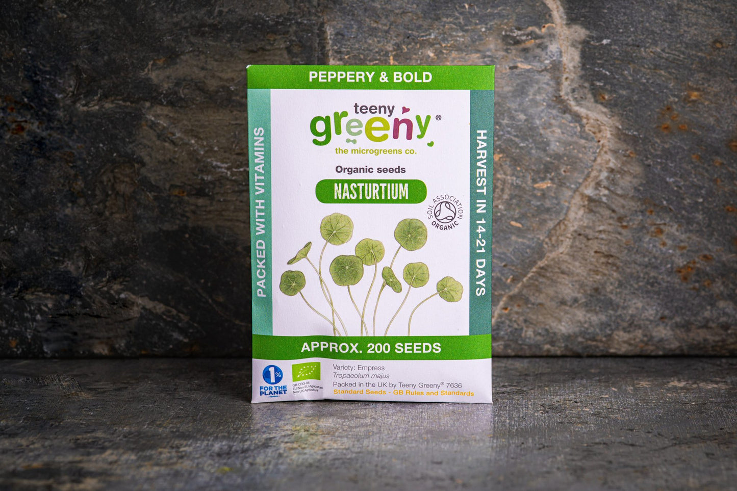 Teeny Greeny organic nasturtium seed packet standing upright on slate background
