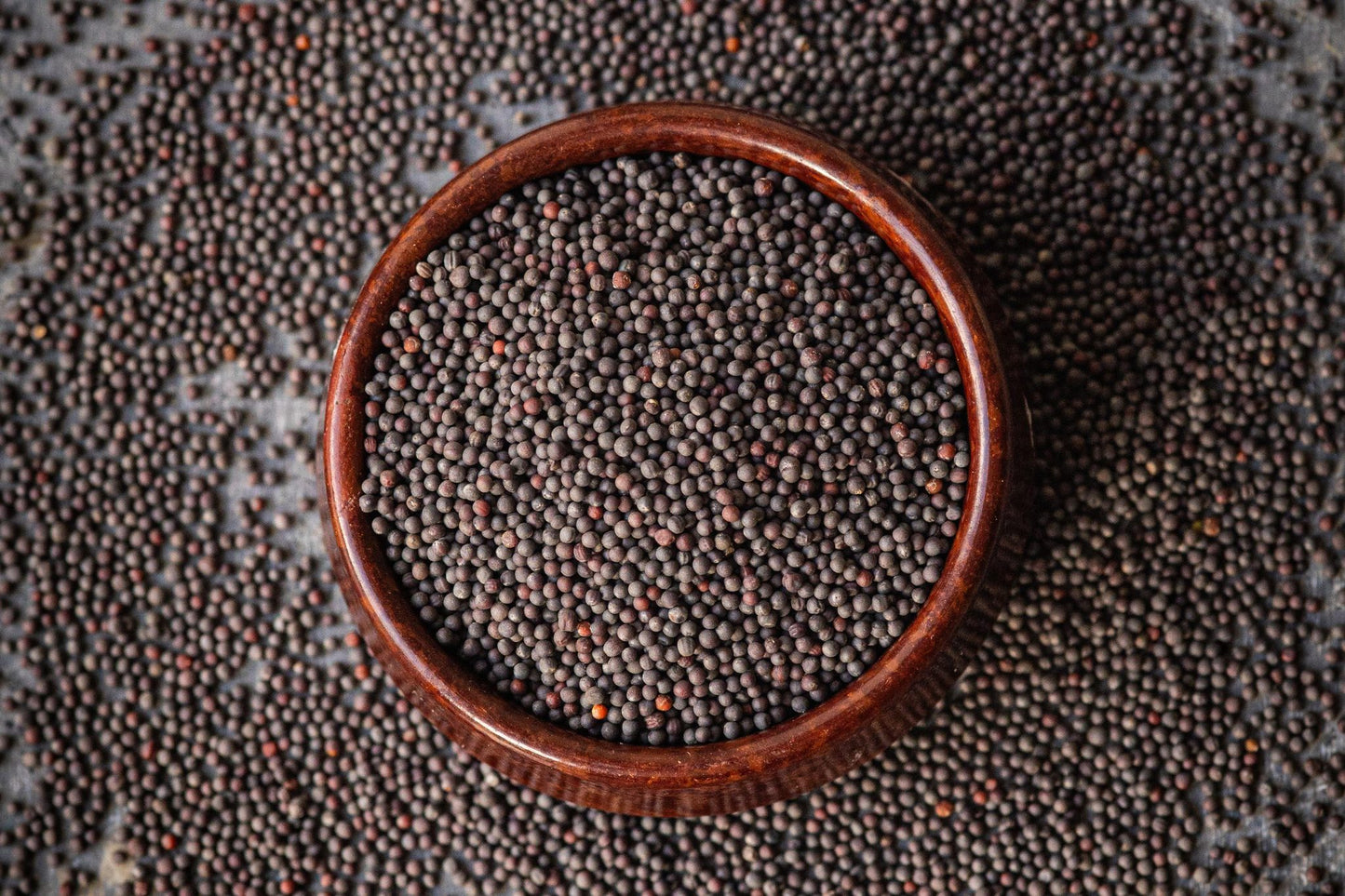 Teeny Greeny organic pak choi microgreen seeds close up in wooden bowl

