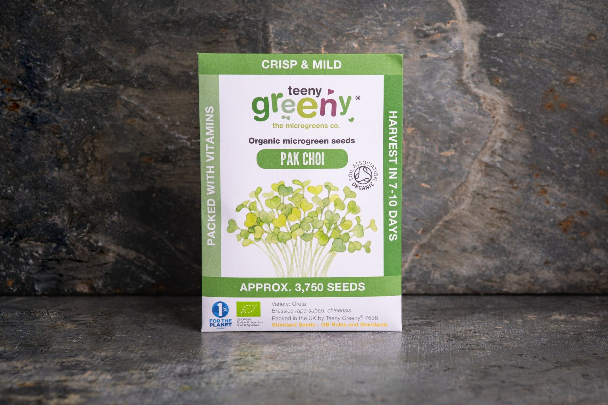 Teeny Greeny organic Pak Choi microgreen seed packet standing upright on dark slate background