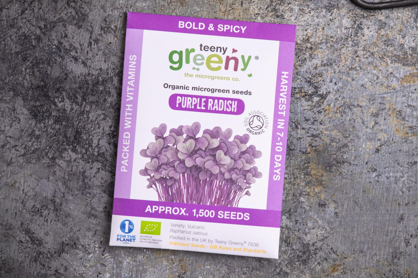 Teeny Greeny organic purple radish microgreen seed packet flat lay on stone surface