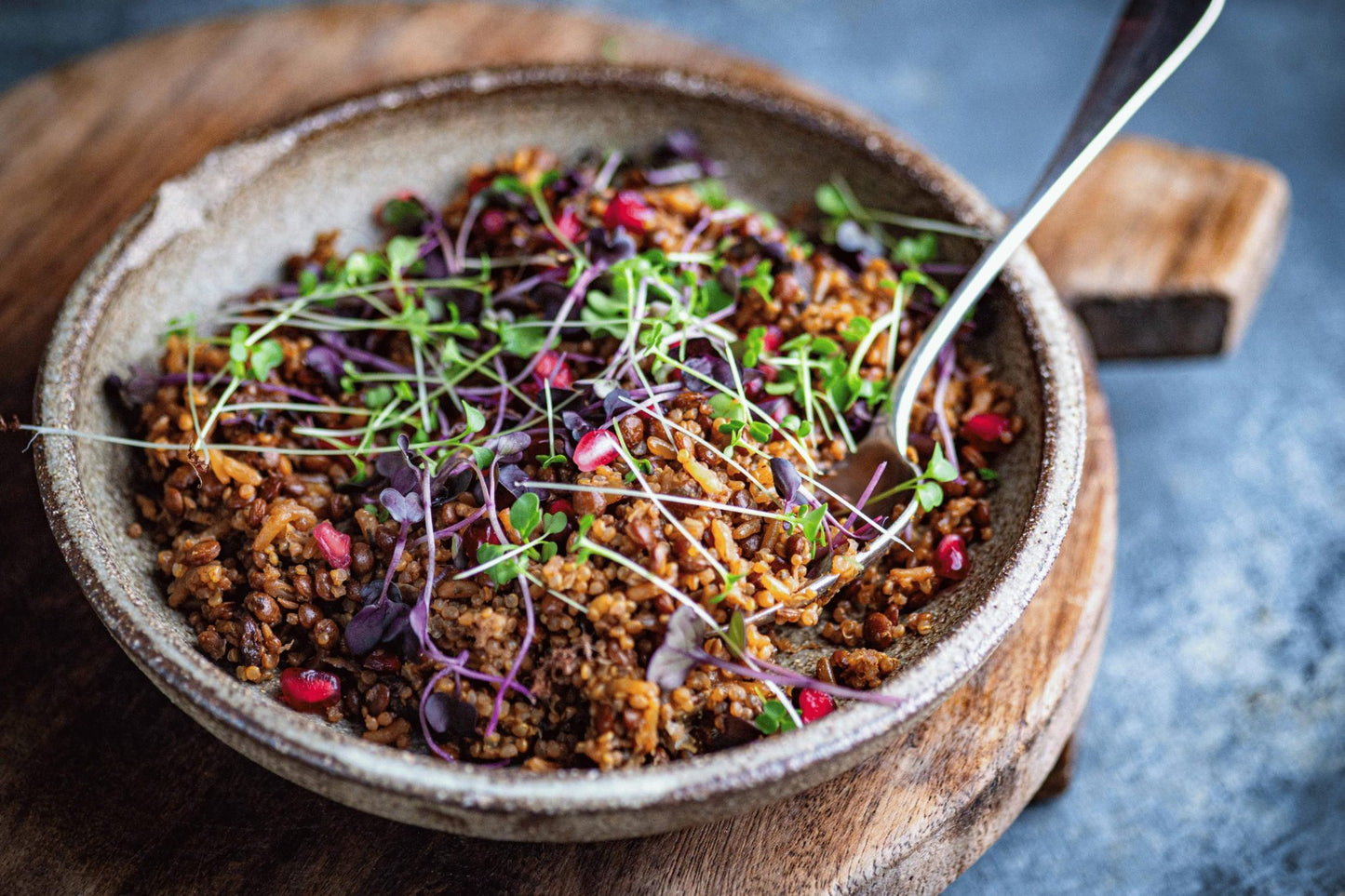 Teeny Greeny red cabbage microgreens as garnish on grain salad with pomegranate
