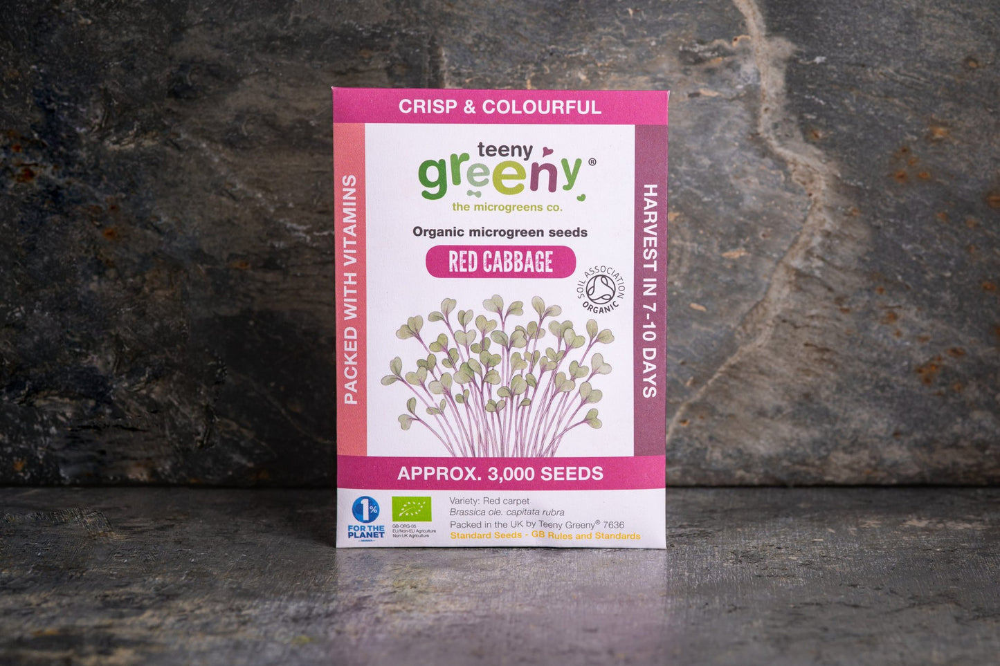 Teeny Greeny organic Red Cabbage microgreen seed packet standing upright on dark slate background