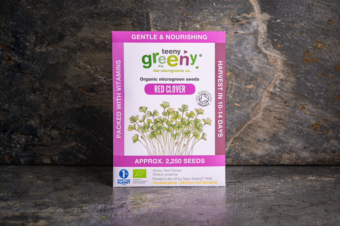 Teeny Greeny organic Red Clover microgreen seed packet standing upright on dark slate background