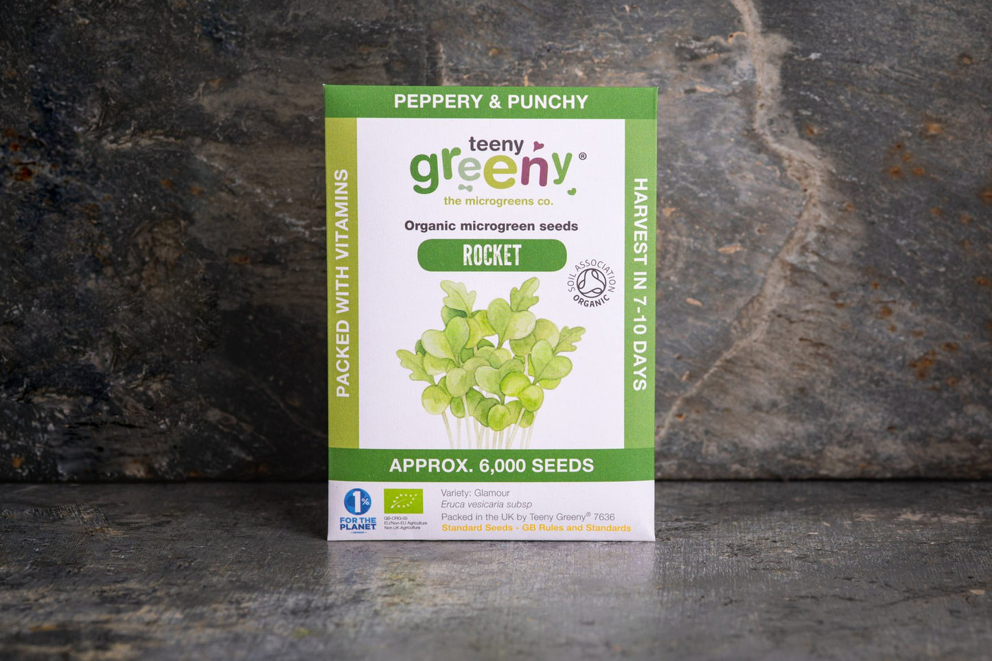 Teeny Greeny organic Rocket microgreen seed packet standing upright on dark slate background