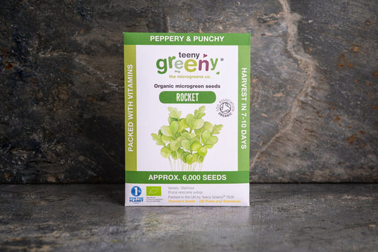 Teeny Greeny organic Rocket microgreen seed packet standing upright on dark slate background