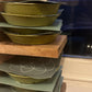 Teeny Greeny microgreen germination covers and bamboo growing trays stacked on wooden shelf showing growing setup
